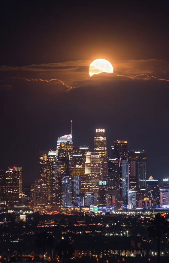 Capturing the enchanting magic of a moonrise over the Los Angeles skyline against the backdrop of Skyline Mountain.