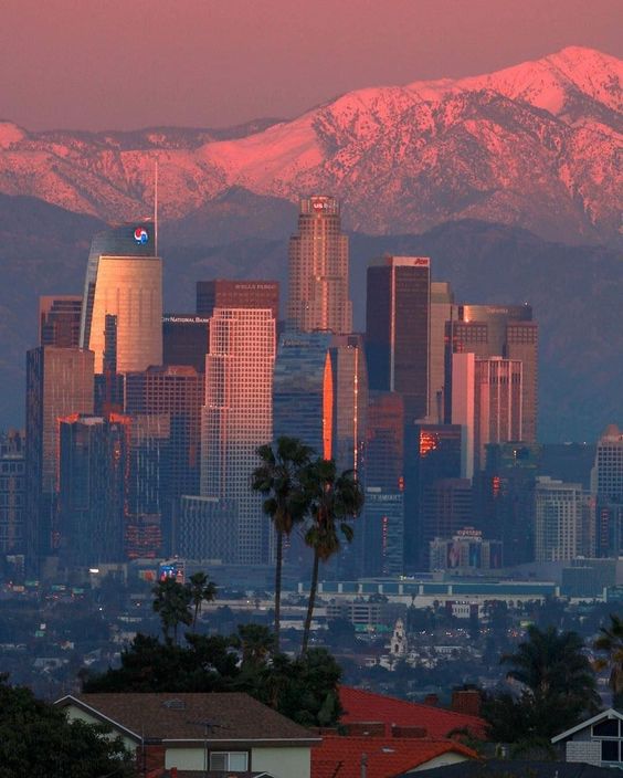 Capturing the enchanting magic of a moonrise over the Los Angeles skyline against the backdrop of Skyline Mountain.