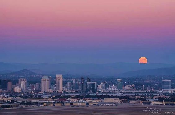 Capturing the enchanting magic of a moonrise over the Los Angeles skyline against the backdrop of Skyline Mountain.