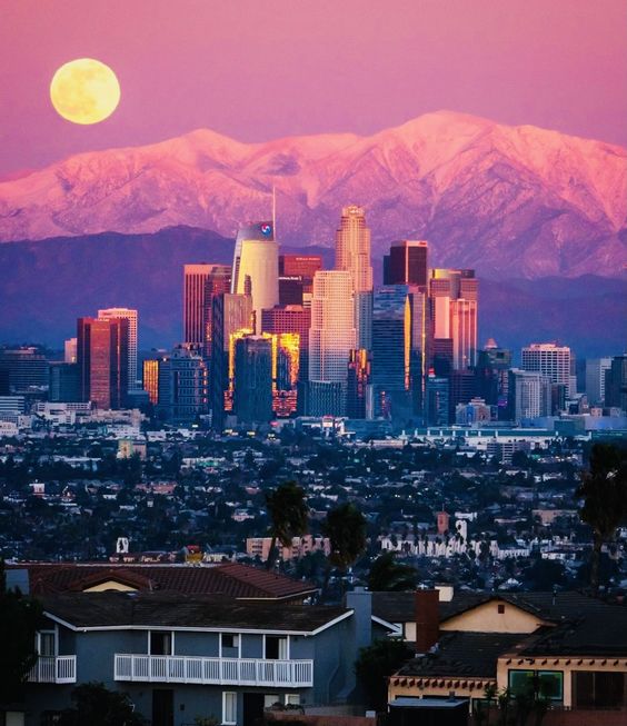 Capturing the enchanting magic of a moonrise over the Los Angeles skyline against the backdrop of Skyline Mountain.